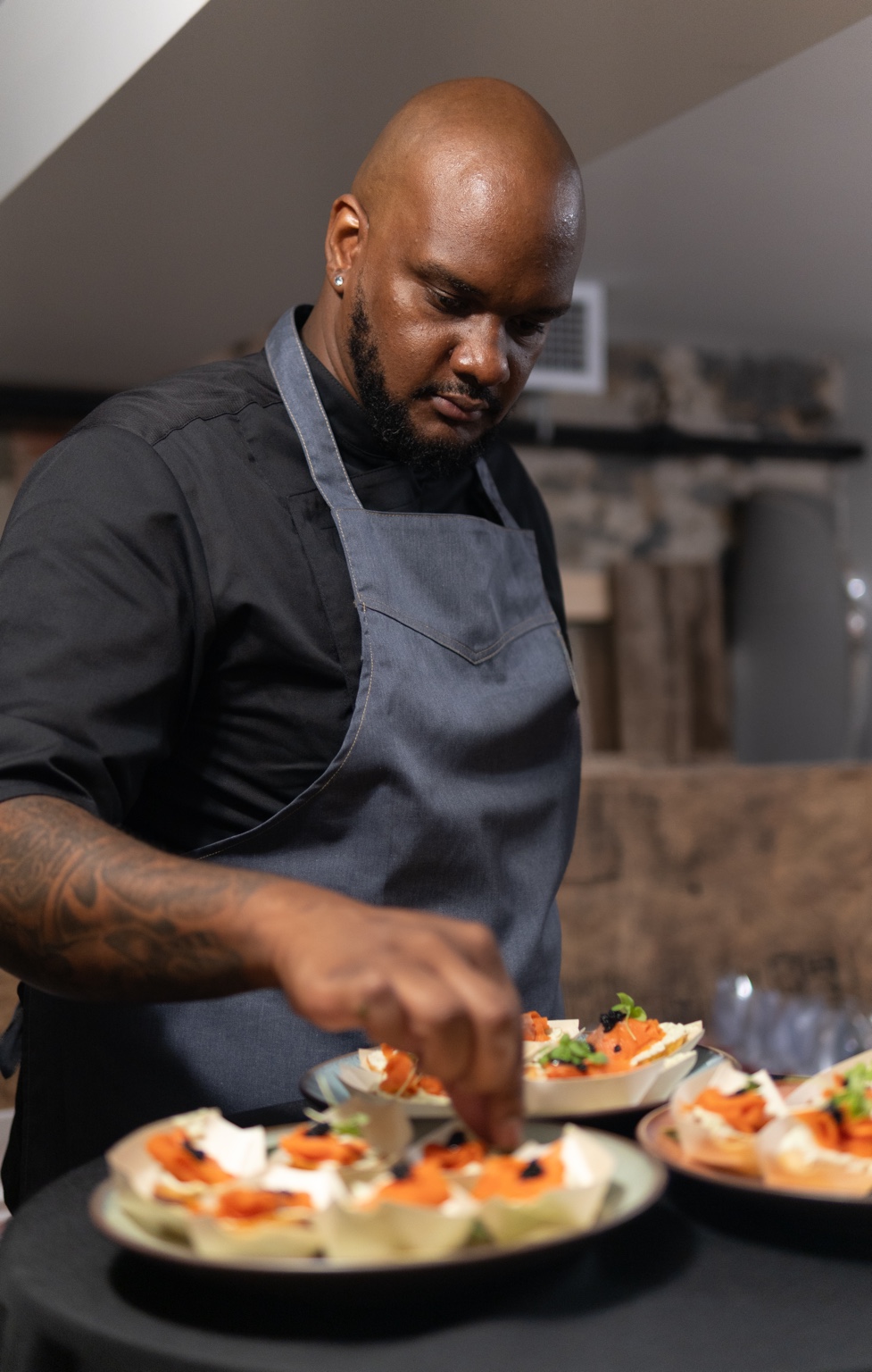 Chef Gibson finishing plates during a private event