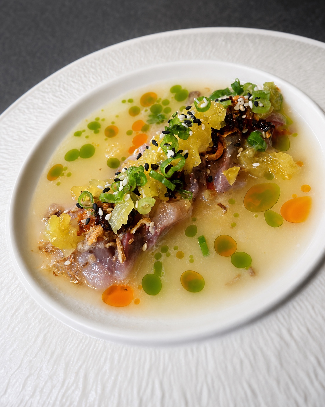 A finely plated crudo course with citrus